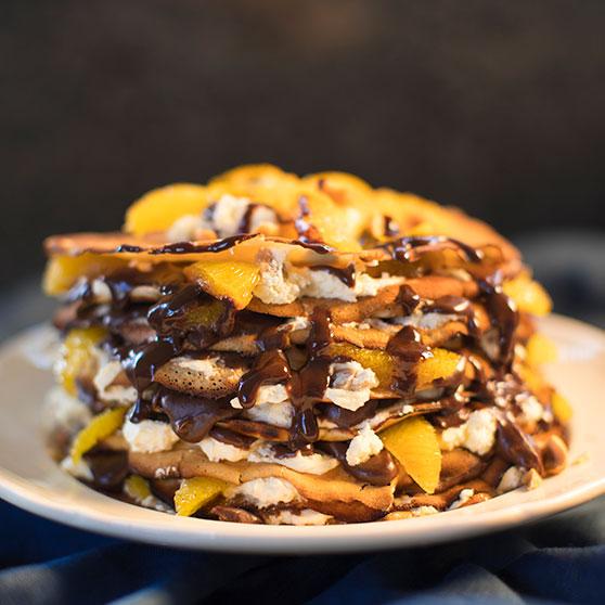 Pancake Stack with Orange Segments, Chocolate Fudge Sauce and Toasted Hazelnuts